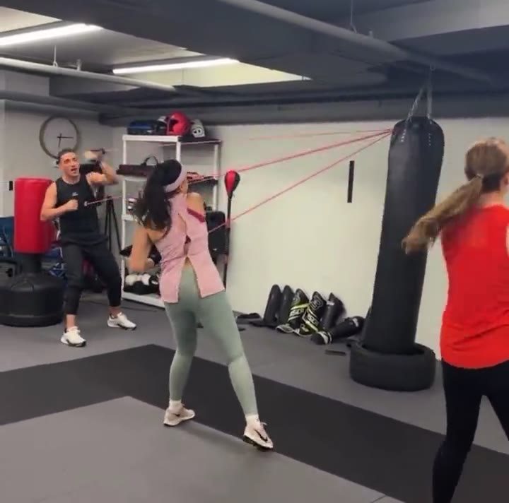 Coach Ali Baradaran leading fitness boxing band work at DKM Academy