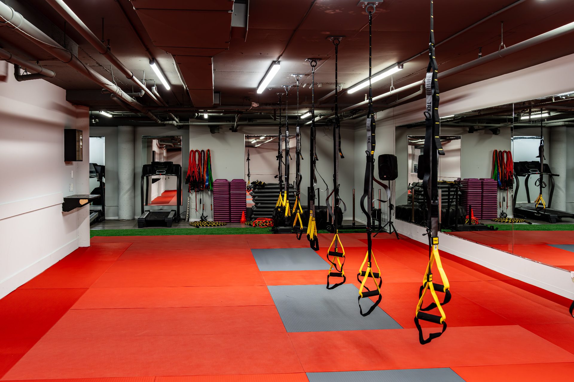 Conditioning zone with TRX, treadmills, steps and turf