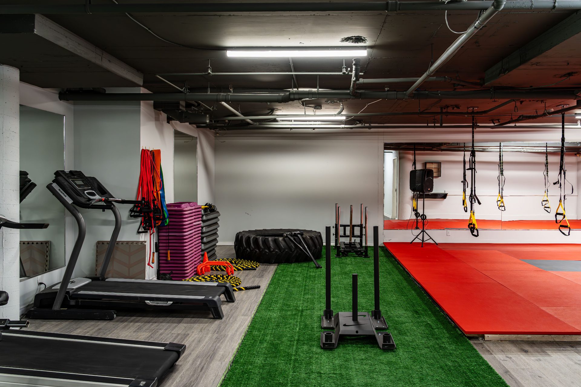Weight sled, battle ropes and grass mat performance area
